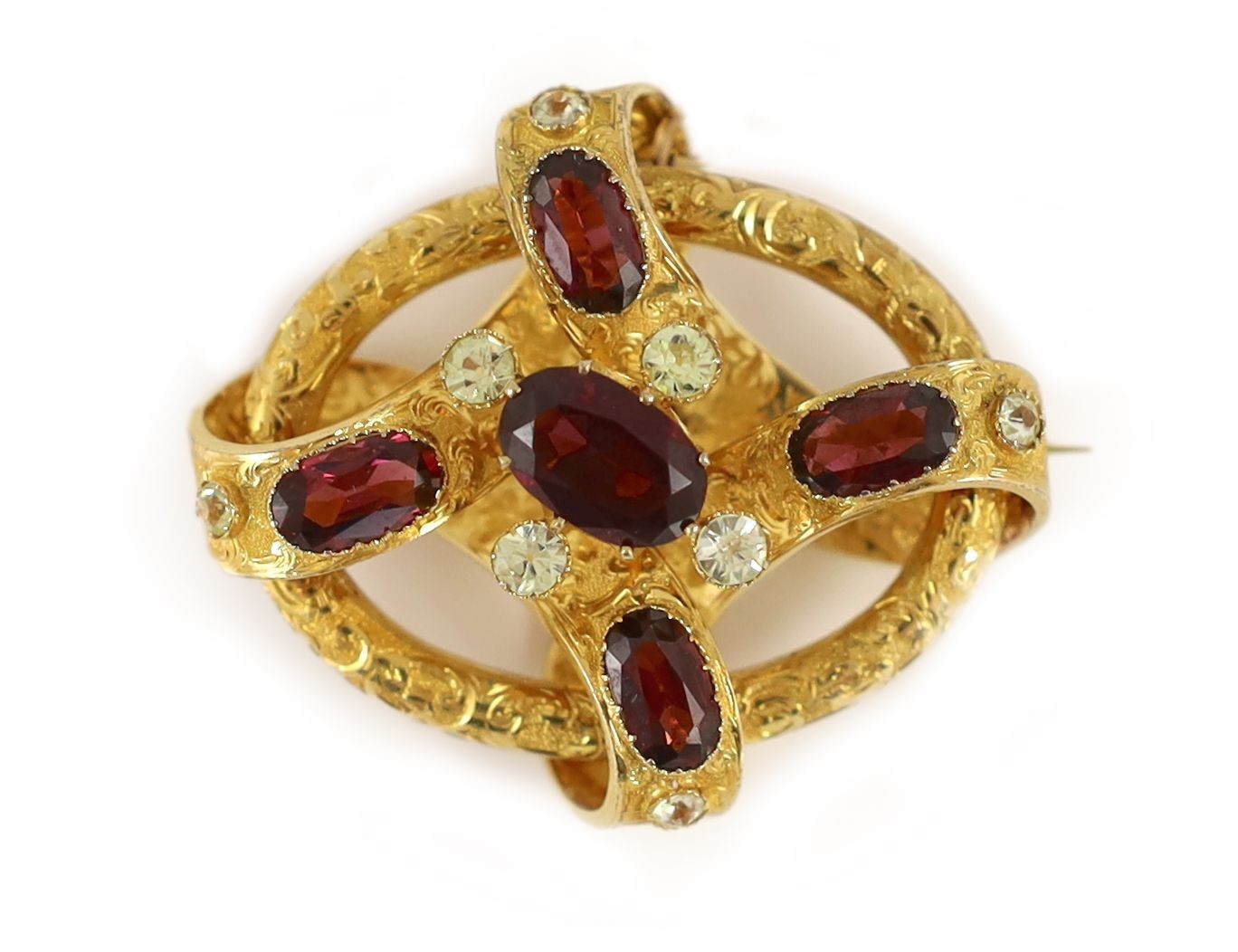 A Victorian engraved gold, chrysoberyl? and garnet set open work scroll brooch